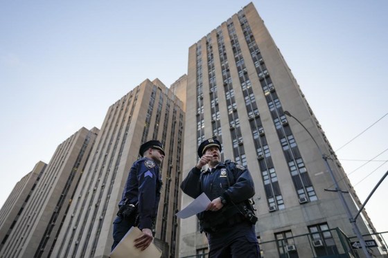 Police officers secure the perimeter outside Manhattan Criminal Court, Tuesday, in New York. (John Minchillo / The Associated Press)