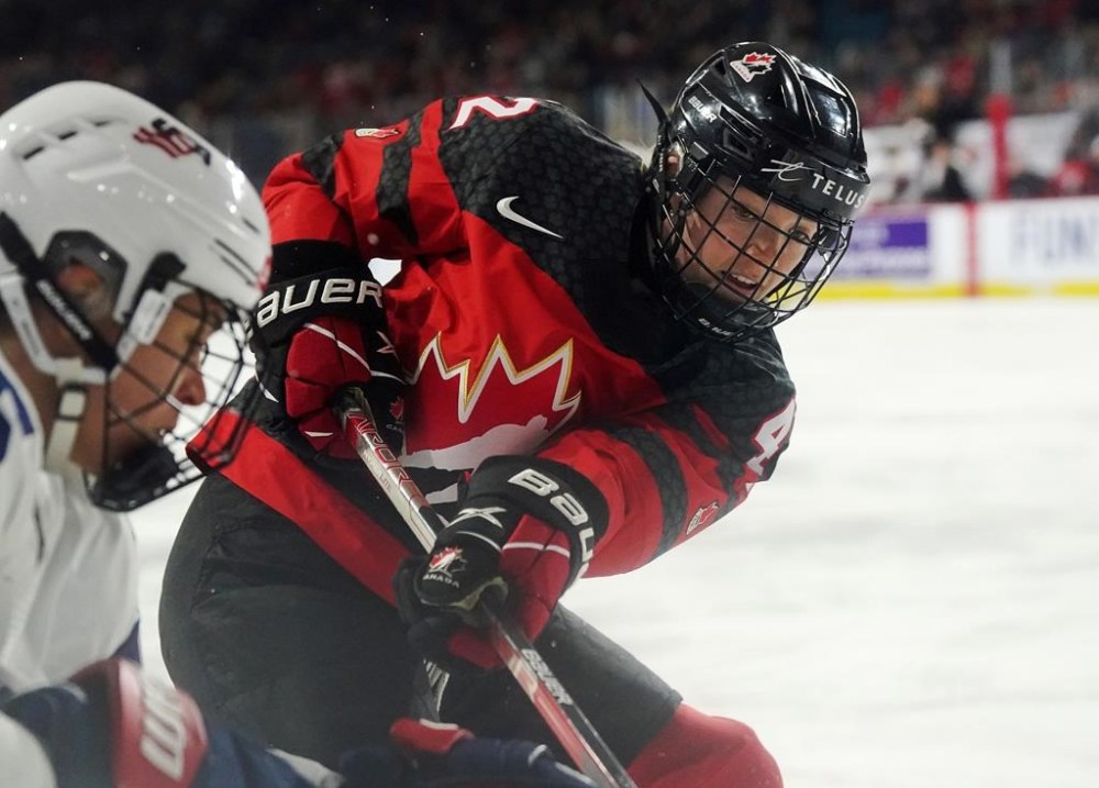 Canada's Claire Thompson (42) battles along the boards against the United States during first period Rivalry Series hockey action in Kamloops, B.C., Thursday, Nov. 17, 2022. Piecing together life as both an NYU medical student and a Canadian women's hockey team defender is a full-time job for the 25-year-old from Toronto. THE CANADIAN PRESS/Jesse Johnston