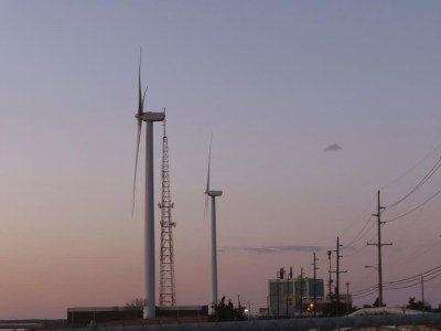 The sun sets behind a land-based wind farm in Atlantic City, N.J. on Feb. 10, 2022. The National Oceanic and Atmospheric Administration on Tuesday, April 4, 2023, issued a report concluding that New Jersey's first planned offshore wind farm, Ocean Wind I, will likely have adverse impacts on whales and other marine animals, but will not seriously harm or kill them. (AP Photo/Wayne Parry)