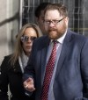 Freedom Corp. counsel Brendan Miller smokes a cigarette as Tamara Lich looks on outside the Public Order Emergency Commission, in Ottawa, Tuesday, Nov. 22, 2022. The lobbying firm that sued the lawyer for the 