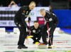 Canadian lead Geoff Walker, left, and Canadian second EJ Harnden sweep as Canadian skip Brad Gushue looks on while playing Japan at the Men's World Curling Championship in Ottawa on Monday, April 3, 2023. THE CANADIAN PRESS/Sean Kilpatrick