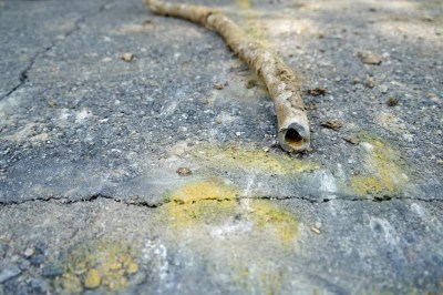 FILE - A lead water service line from 1927 lays on the ground on a residential street after being removed on June 17, 2021, in Denver. Some 9.2 million lead pipes carry water into homes across the U.S., with more in Florida than any other state, according to a new Environmental Protection Agency survey that will dictate how billions of dollars to find and replace those pipes are spent. (AP Photo/Brittany Peterson, File)