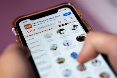 A person navigates the Temu website on a smartphone in Toronto, Tuesday, April 4, 2023. Temu launched in Canada in early February, the same month it aired a Super Bowl ad with the tagline 