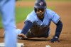 Toronto Blue Jays' Kevin Kiermaier dives safely back to first on a pickoff attempt during the seventh inning of a baseball game against the Kansas City Royals, Tuesday, April 4, 2023, in Kansas City, Mo. (AP Photo/Reed Hoffmann)