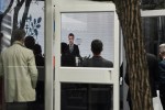 People look at a screen of the French President Emmanuel Macron giving a speech as he meets the French community, in Beijing, China, Wednesday, April 5, 2023. Macron will have to muster all his diplomatic adeptness and political acumen on a three-day state visit to China where the war in Ukraine will be front and center. (AP Photo/Thibault Camus)