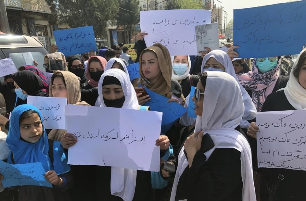FILE - Afghan women chant and hold signs of protest during a demonstration in Kabul, Afghanistan, March 26, 2022. The U.N. said Wednesday, April 5, 2023, that it cannot accept a Taliban decision to bar Afghan female staffers from working at the agency, calling it an “unparalleled” violation of women's rights. (AP Photo/Mohammed Shoaib Amin, File)