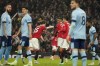 Manchester United's Marcus Rashford, center, celebrates with his teammates after scoring his side's first goal during the English Premier League soccer match between Manchester United and Brentford, at the Old Trafford stadium in Manchester, England, Wednesday, April 5, 2023. (AP Photo/Dave Thompson)