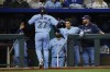 Toronto Blue Jays' Vladimir Guerrero Jr. (27) is congratulated at the dugout after scoring during the first inning of the team's baseball game against the Kansas City Royals in Kansas City, Mo., Wednesday, April 5, 2023. (AP Photo/Colin E. Braley)