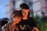 A mother and her son attend a vigil outside the 