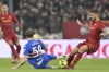 Roma's Leonardo Spinazzola, right, is tackled by Sampdoria's Alessandro Zanoli the Serie A soccer match between Roma and Sampdoria at the Rome Olympic stadium Sunday, April 2, 2023. (Alfredo Falcone/LaPresse via AP)