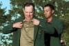 FILE - 1997 Masters champion Tiger Woods, right, helps 1998 Masters champion Mark O'Meara put on his Green Jacket after he won the tournament at the Augusta National Golf Club in Augusta, Ga., Sunday, April 12, 1998. O'Meara won his first major 25 years ago this week. (AP Photo/Amy Sancetta, File)