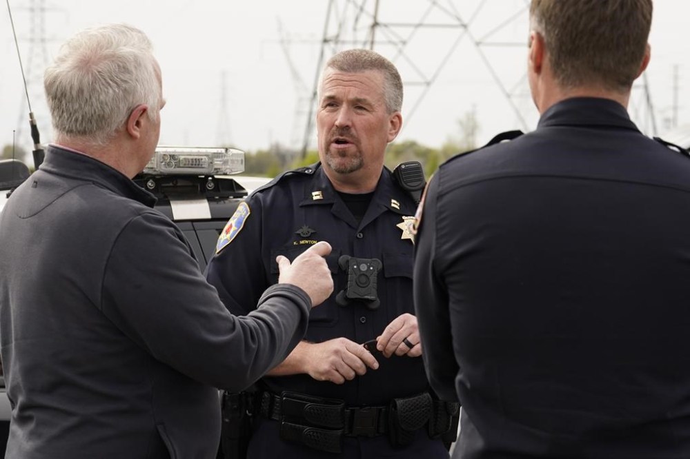 Roseville Police Captain Kelby Newton talks to a reporter about the shooting that killed one person and wounded two others including a California Highway Patrol office, in Roseville, Calif., Thursday, April 6, 2023. California Highway Patrol officers were serving a warrant to the suspect when he began shooting. Two innocent bystanders were struck by the suspect's gunfire, killing one. The suspect surrendered and taken into custody..(AP Photo/Rich Pedroncelli)