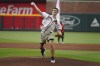 Former Georgia quarterback Stetson Bennett throws out the ceremonial first pitch before baseball game between the Atlanta Braves and the San Diego Padres, Thursday, April 6, 2023, in Atlanta. (AP Photo/John Bazemore)