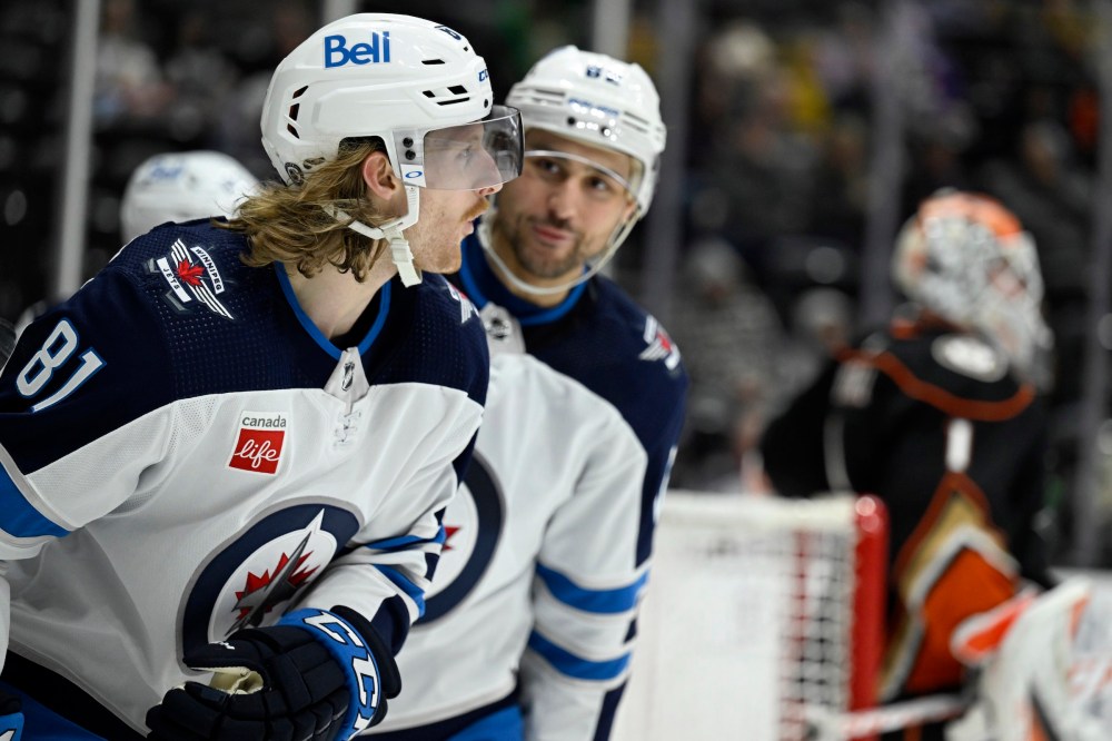 Winnipeg Jets left wing Kyle Connor, left, reacts after scoring against Anaheim Ducks goaltender Lukas Dostal, right, with teammate Nino Niederreiter, looking on during the second period. (AP Photo/Alex Gallardo)