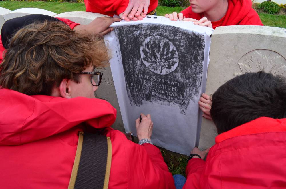 SUPPLIED
Aidan Nowicki uses a piece of carbon to create a copy of Private Ernest James Smith’s gravestone at the Sancourt British Cemetery in Nord, France on April 6.