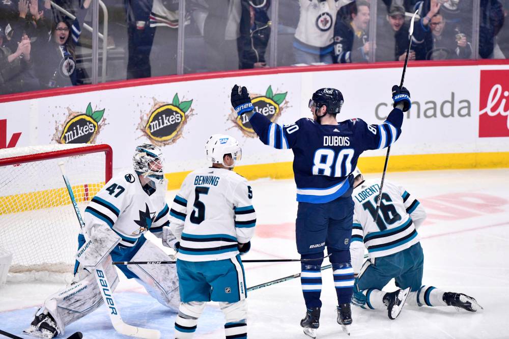 FRED GREENSLADE / THE CANADIAN PRESS
                                Winnipeg Jets’ Pierre-Luc Dubois (80) celebrates his goal against San Jose Sharks goaltender James Reimer (47) during first period NHL action in Winnipeg.