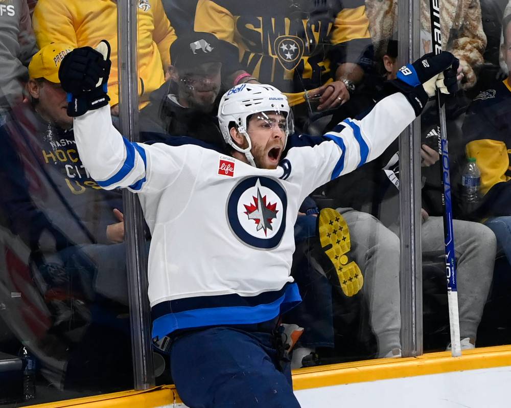 Winnipeg Jets center Adam Lowry (17) celebrates after scoring the tying goal against the Nashville Predators during the third period of game in March. The Jets won in overtime 3-2. (Mark Zaleski / The Associated Press files)