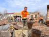 MELISSA MARTIN / WINNIPEG FREE PRESS 
                                University of Manitoba student William Lazarenko, 22, clears rubble from the ruins of Nataliya Sheynich’s home, which was partly destroyed last year during battles in the Kyiv region of Ukraine. Lazarenko was volunteering with Brave to Rebuild, a Ukrainian NGO.