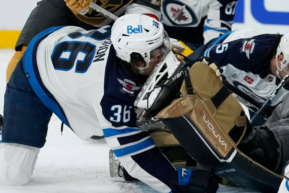 John Locher / The Associated Press
Morgan Barron’s face gets sliced by the skate of Vegas Golden Knights goaltender Laurent Brossoit during first-period action on Monday in Las Vegas.