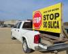 Jordan Ross / The Carillon
                                A truck with a sign voicing opposition to Sio Silica’s plans is parked outside an environmental hearing.