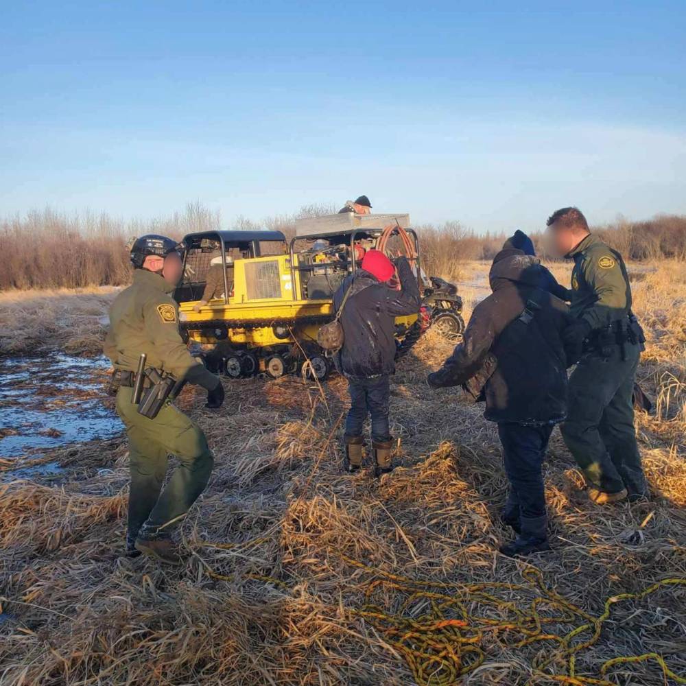 SUPPLIED 
                                U.S. authorities found the men in a flooded bog about 12 km south of the border, after one of the migrants made an emergency phone call that was received by RCMP. Photos blurred by U.S. Customs and Border Protection.