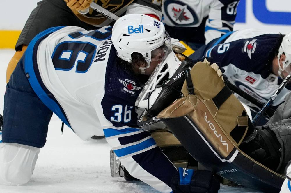 Morgan Barron’s face hit the sake of Vegas goalie Laurent Brossoit during the first period on Tuesday. (John Locher / The Associated Press files)