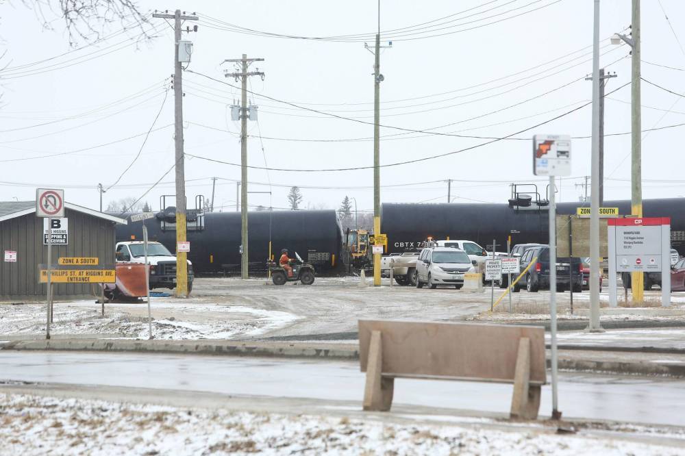 Crews from the WFPS and CP Rail attend a train derailment at the McPhillips Street underpass Friday morning. McPhillips Street will be closed for most of the day. (Mike Deal / Winnipeg Free Press)