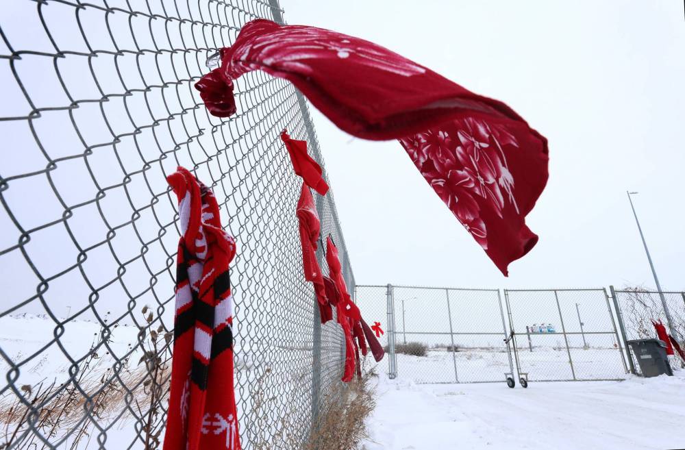 Red dresses and material are seen at Brady Road landfill in December 2022, where a group supporting search efforts for remains of murdered women protested. (Ruth Bonneville / Winnipeg Free Press files)