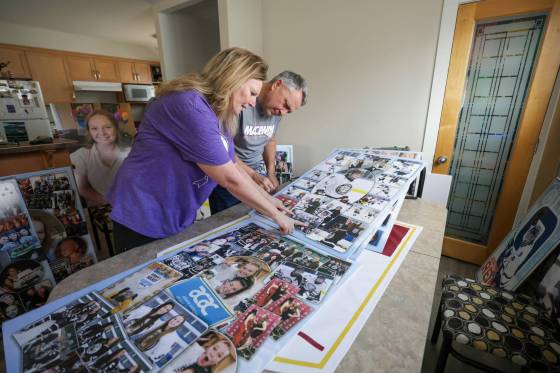 Karen and Doug Reimer, parents of Jordyn, spread out photographs of their late daughter that they had made into poster boards for her memorial. (Ruth Bonneville / Winnipeg Free Press)