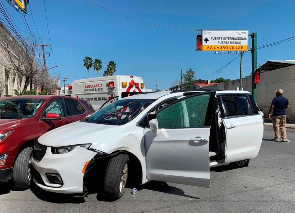 FILE - A member of the Mexican security forces stands next to a white minivan with North Carolina plates and several bullet holes, at the crime scene where gunmen kidnapped four U.S. citizens who crossed into Mexico from Texas, on March 3, 2023. A man who admitted to purchasing firearms that he knew would be going from the U.S. to a Mexican drug cartel has been arrested in Texas after the discovery that one of the weapons was linked to the deadly kidnapping of four Americans in the border city of Matamoros, according federal court records, Saturday, March 18. (AP Photo, File)