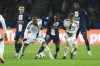 PSG's Renato Sanches, centre, challenges for the ball with Lyon's Johann Lepenant, second from right, and Lyon's Alexandre Lacazette, second from left, during the French League One soccer match between Paris Saint-Germain and Lyon at the Parc des Princes stadium in Paris, Sunday, April 2, 2023. (AP Photo/Aurelien Morissard)