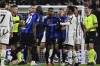 Inter Milan's Romelu Lukaku (90) and Juventus' Juan Cuadrado argue following the Italian cup semi final first leg soccer match between Juventus and Inter Milan, at the Allianz Stadium, in Turin, Italy, Tuesday, April 4, 2023. (Marco Alpozzi/LaPresse via AP)