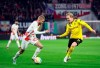 Leipzig's Konrad Laimer, left, and Dortmund's Julian Brandt fight for the ball during the quarterfinal DFB Cup soccer match between RB Leipzig and Borussia Dortmund at the Red Bull Arena in Leipzig, Germany, Wednesday April 5, 2023. (Jan Woitas/dpa via AP)