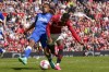 Manchester United's Marcus Rashford, right, is tackled by Everton's Alex Iwobi nduring the English Premier League soccer match between Manchester United and Everton, at the Old Trafford stadium in Manchester, England, Saturday, April 8, 2023. (AP Photo/Dave Thompson)
