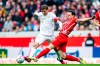 Munich's Thomas Muller, left, and Freiburg's Nicolas Hofler battle for the ball during the Bundesliga soccer match between SC Freiburg and Bayern Munich at Europa-Park Stadion, Freiburg, Germany, Saturday April 8, 2023. (Tom Weller/dpa via AP)