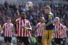 Brentford's Ivan Toney, left, and Newcastle's Kieran Trippier hump for a header during the English Premier League soccer match between Brentford and Newcastle United at the Gtech Community stadium, in London, England, Saturday, April 8, 2023. (AP Photo/Alastair Grant)