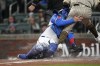CORRECTS THAT ODOR WAS OUT, NOT SAFE - San Diego Padres' Rougned Odor (24) collides with Atlanta Braves catcher Travis d'Arnaud (16) as he is tagged out during the fourth inning of a baseball game Saturday, April 8, 2023, in Atlanta. (AP Photo/John Bazemore)