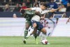 Vancouver Whitecaps FC's Mathias Laborda (right) and Portland Timbers' Tega Ikoba battle for possession of the ball during first half MLS soccer action in Vancouver, B.C., Saturday, April 8, 2023. THE CANADIAN PRESS/Rich Lam