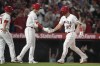 Los Angeles Angels' Mike Trout (27) is greeted by designated hitter Shohei Ohtani after hitting a home run during the fifth inning of a baseball game against the Toronto Blue Jays in Anaheim, Calif., Saturday, April 8, 2023. Matt Thaiss and Taylor Ward also scored. (AP Photo/Ashley Landis)