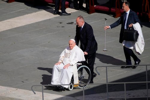 Pope Francis arrives in a wheelchair in St. Peter's Square at The Vatican where he will celebrate the Easter Sunday mass, Sunday, April 9, 2023. (AP Photo/Gregorio Borgia)