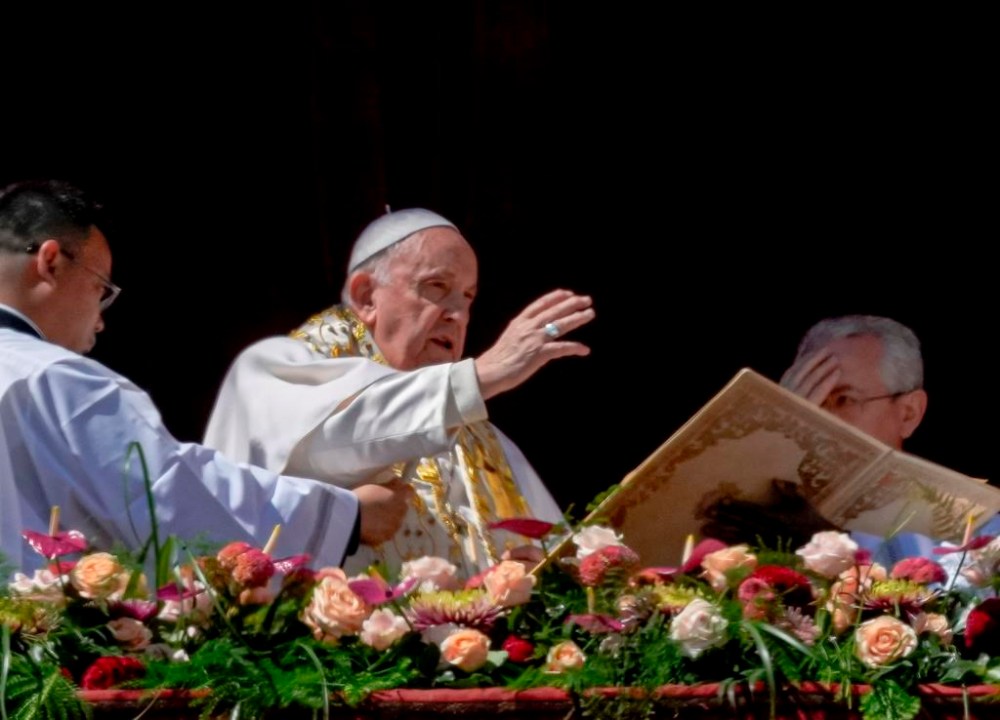 Pope Francis bestows the plenary 'Urbi et Orbi' (to the city and to the world) blessing from the central lodge of the St. Peter's Basilica at The Vatican at the end of the Easter Sunday mass, Sunday, April 9, 2023. (AP Photo/Alessandra Tarantino)