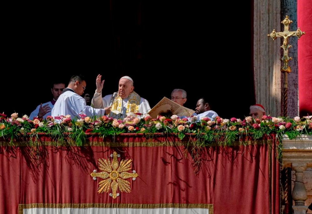 Pope Francis bestows the plenary 'Urbi et Orbi' (to the city and to the world) blessing from the central lodge of the St. Peter's Basilica at The Vatican at the end of the Easter Sunday mass, Sunday, April 9, 2023. (AP Photo/Alessandra Tarantino)