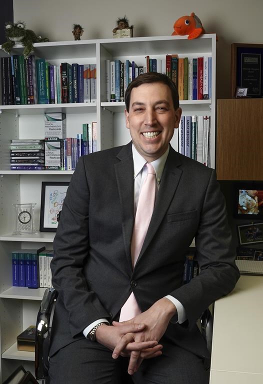 American Medical Association President-Elect Dr. Jesse M. Ehrenfeld poses for a picture in his office at the Medical College of Wisconsin Friday, March 24, 2023, in Milwaukee. At 44, Ehrenfeld will be among the AMA's youngest presidents when he begins his one-year term on June 13. (AP Photo/Morry Gash)