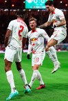 Leipzig's Timo Werner, center, celebrates with his teammates after scoring to 1-0 during the quarterfinal DFB Cup soccer match between RB Leipzig and Borussia Dortmund at the Red Bull Arena in Leipzig, Germany, Wednesday April 5, 2023. (Jan Woitas/dpa via AP)