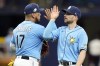 Tampa Bay Rays second baseman Brandon Lowe high fives third baseman Isaac Paredes (17) after the team defeated the Oakland Athletics during a baseball game Sunday, April 9, 2023, in St. Petersburg, Fla. (AP Photo/Chris O'Meara)