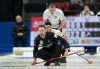 Scotland lead Hammy McMilllan and second Bobby Lammie look over the shoulder of Canada skip Brad Gushue as he calls to teammates and his shot enters the house in the fifth end during action in the finals at the Men's World Curling Championship in Ottawa on Sunday, April 9, 2023. THE CANADIAN PRESS/Adrian Wyld