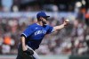 Kansas City Royals pitcher Kris Bubic throws to first for an out on a ball hit by San Francisco Giants' Thairo Estrada during the third inning of a baseball game in San Francisco, Sunday, April 9, 2023. (AP Photo/Godofredo A. Vásquez)