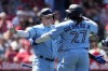 Toronto Blue Jays' Matt Chapman, left, is hugged by Vladimir Guerrero Jr. (27) after Chapman's grand-slam during the sixth inning of a baseball game Los Angeles Angels, in Anaheim, Calif., Sunday, April 9, 2023. Chapman has been named American League player of the week. THE CANADIAN PRESS/AP-Marcio Jose Sanchez