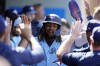 Toronto Blue Jays' Vladimir Guerrero Jr. is high-fived in the dugout after scoring on a single by Whit Merrifield during the seventh inning of a baseball game against the Los Angeles Angels, Sunday, April 9, 2023, in Anaheim, Calif. Toronto is set to play its home opener tonight against the Detroit Tigers in the first of a three-game series. THE CANADIAN PRESS/AP-Marcio Jose Sanchez