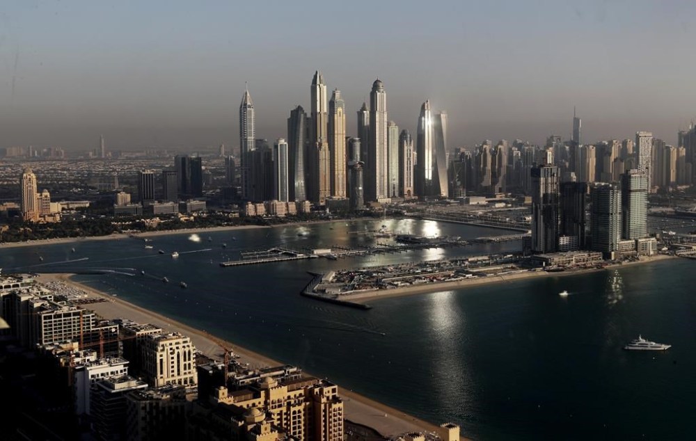 FILE - Luxury towers dominate the skyline in the Marina district, center, and the new Dubai Harbour development, right, are seen from the observation deck of